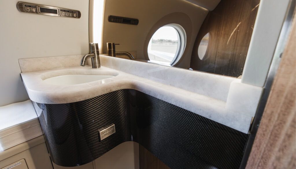 Curved sink in G550 lavatory with carbon fibre and stone finishes