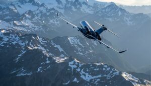 Aircraft flying over snow-covered mountain peaks