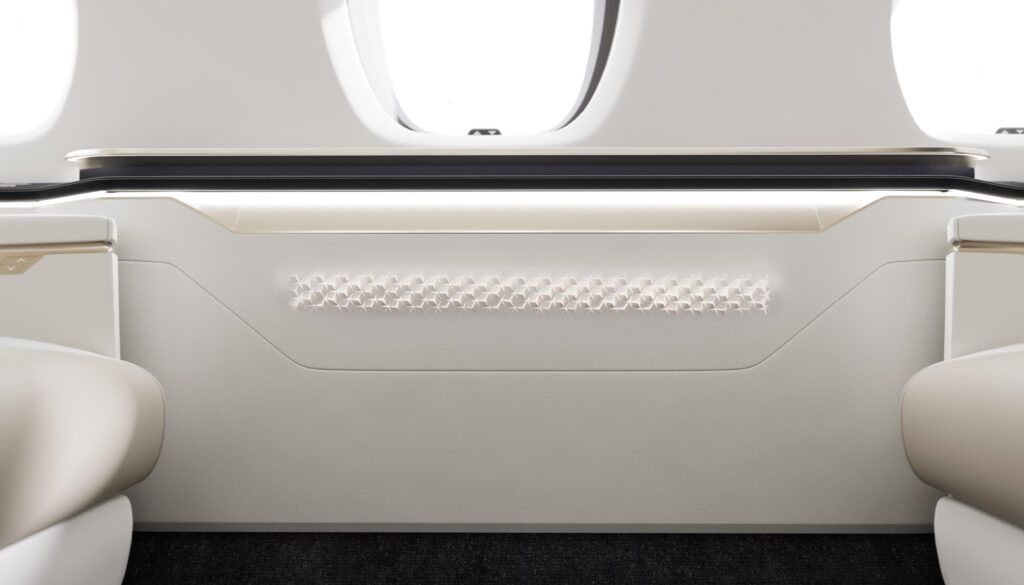 Business jet interior with perforated leather pattern on sidewall underneath window