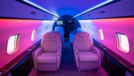 Luxurious private jet interior with purple lighting