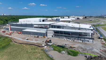 Large aviation hangars under construction at airport facility