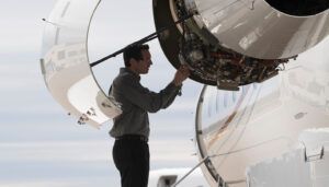 Technician inspecting aircraft engine