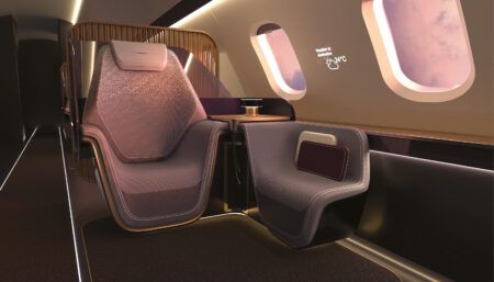 Private jet interior with sculpturally shaped main and companion seats
