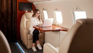Businesswoman works on laptop in private jet