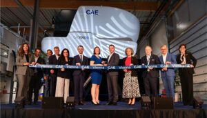 Ribbon-cutting ceremony with flight simulator backdrop