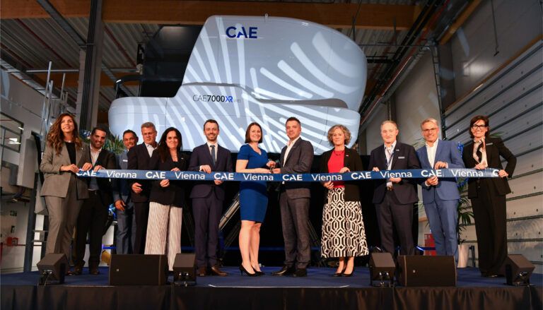 Ribbon-cutting ceremony with flight simulator backdrop