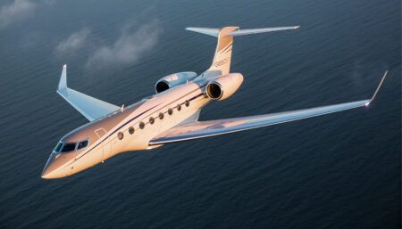 Business jet flying over water