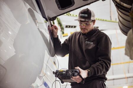 Technician performing aircraft inspection