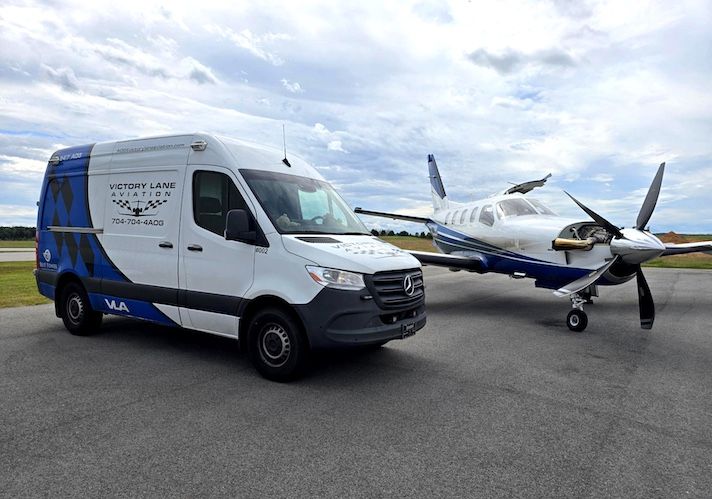TBM aircraft and Victory Lane Aviation van