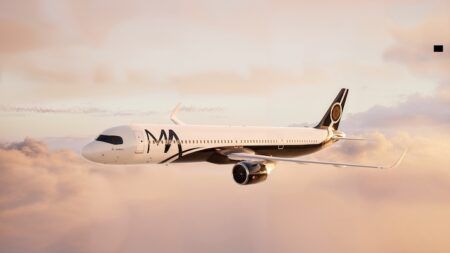 White commercial aircraft flying through pink sunset clouds