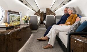 Couple relaxing on sofa in luxurious private jet cabin
