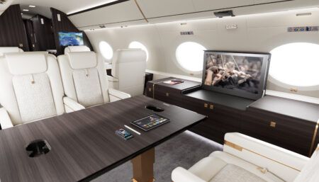Private jet with white leather seats and pop-up IFE screen