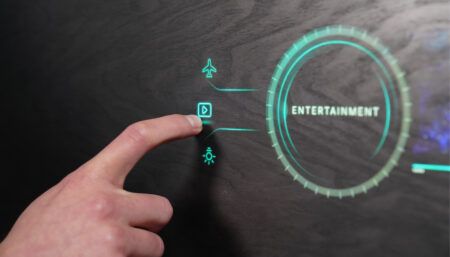 Hand touching blue CMS icon on wood-look surface