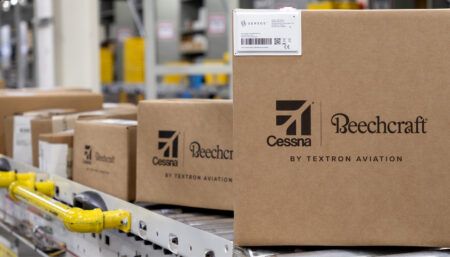 Aircraft parts boxes with white Sensos label on conveyor belt