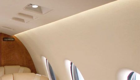 Closeup of business jet sidewall with recessed spotlights