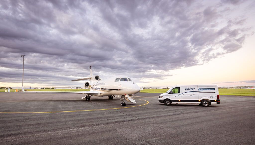 Business jet with mobile response team van parked on tarmac