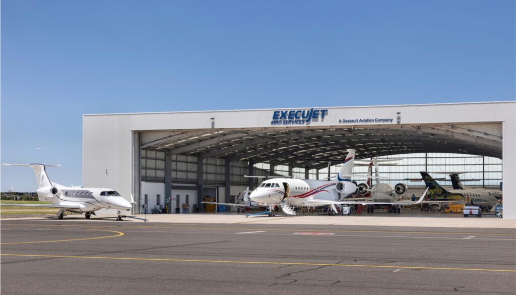 Hangar facility with multiple business jets on apron