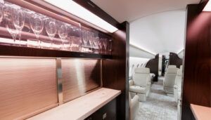 Business jet galley with illuminated glassware storage