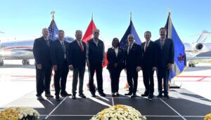 Group photo in front of private jets