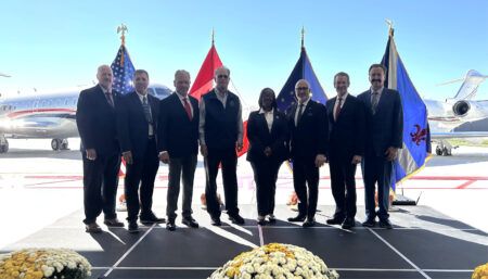 Group photo in front of private jets