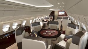 Luxury private jet interior with cream seats and dining table