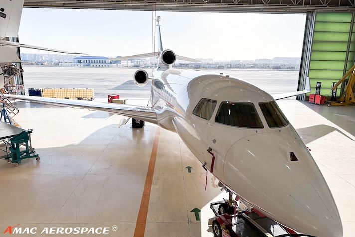 Business jet nose section inside AMAC Aerospace hangar