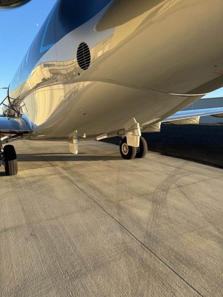 Private jet exterior detail showing fuselage and landing gear