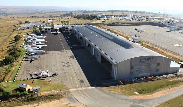 Aerial view of ExecuJet hangar with aircraft and helicopter