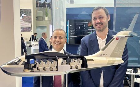 Two men presenting aircraft cabin model at JEKTA exhibition booth
