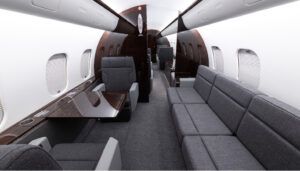 Global 5000 interior with grey upholstery and dark veneer