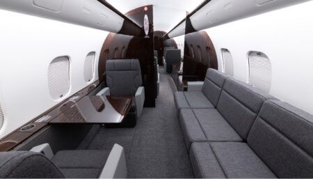 Global 5000 interior with grey upholstery and dark veneer