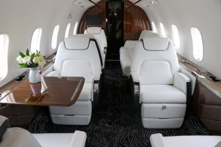 Luxury private jet interior with white leather seats