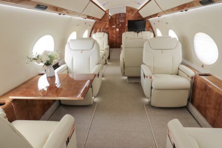Duncan Aviation refurbishes G650 interior and paint Luxurious private jet interior with cream leather seats and wood
