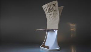 Mockup of sculptural cabin structure with complex, organic-looking decorative pattern of perforations and recesses, and attached table