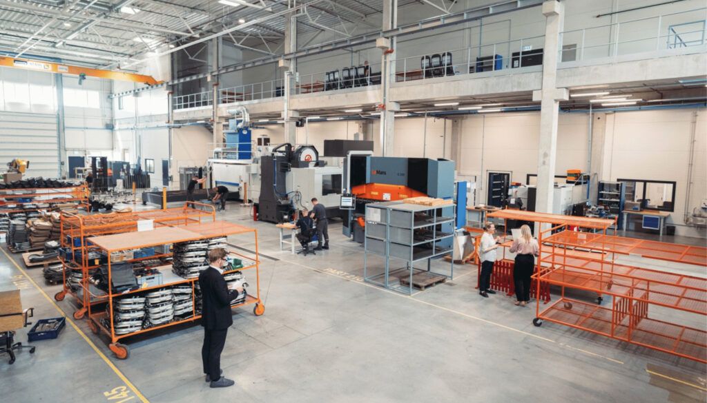 Industrial manufacturing floor with machinery and workers