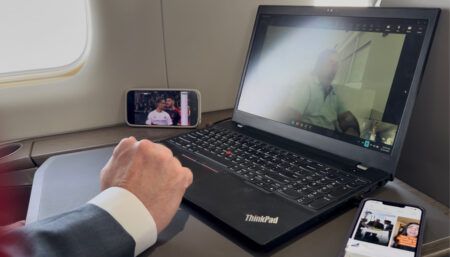 Person working on laptop whilst travelling on private aircraft