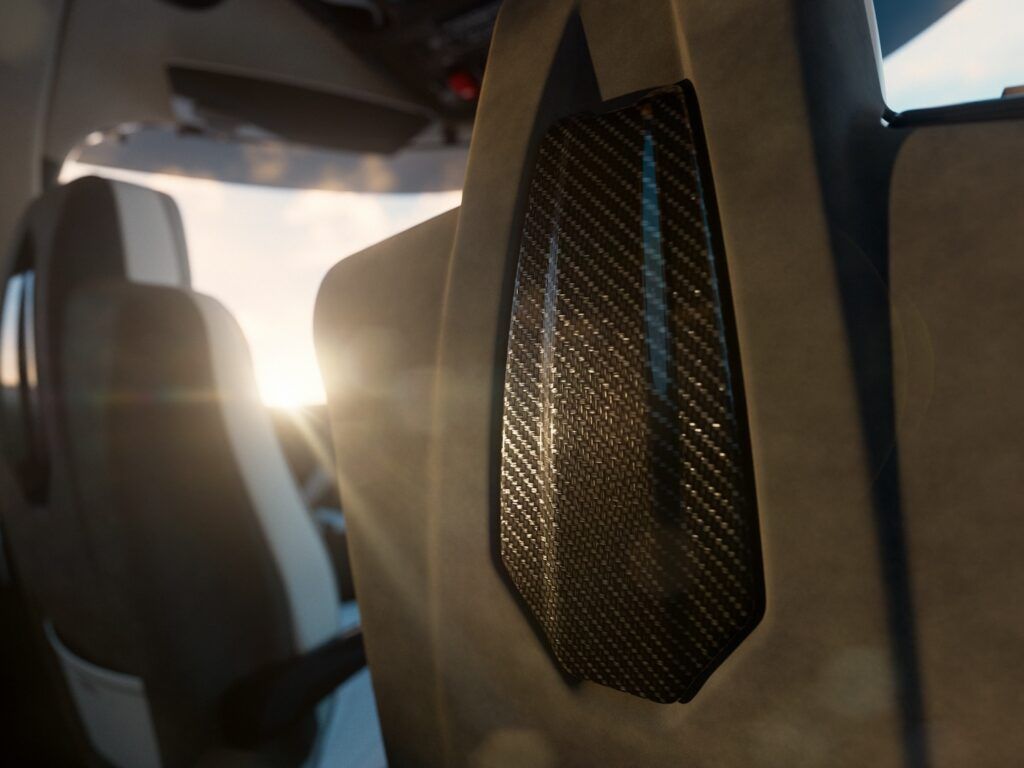 Close-up detail of carbon fibre seatback panel on Cirrus G3 Vision Jet Arrivée trim aircraft with visible weave pattern