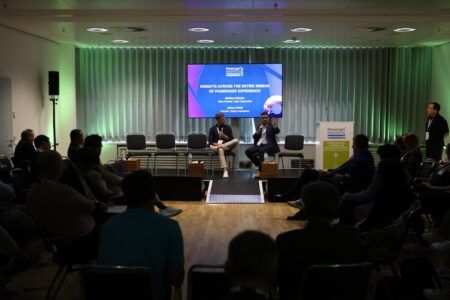 PEC 2026 to address wellness, digital tools and sustainability Conference panel discussion with two speakers seated on stage in front of a projected presentation slide titled ‘Insights Across the Entire Ribbon of Passenger Experience’ with green ambient lighting and seated audience