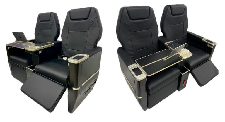 Two render views of the Starling Aerospace SA5000 corporate aircraft seat in black leather with gold-tone fittings, showing extended footrests, fold-out tables and tablet holders