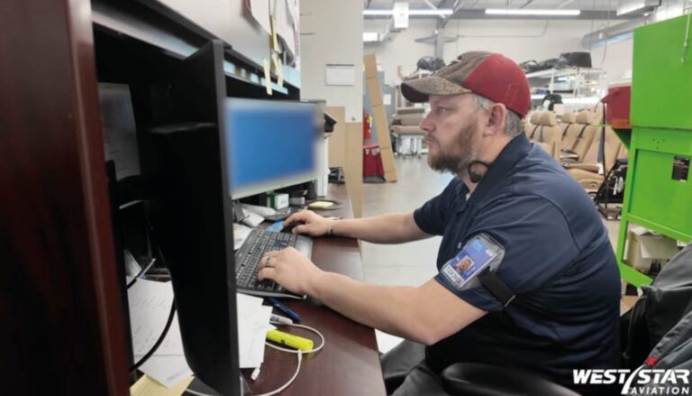 James Johnson working at a computer workstation on the production facility floor