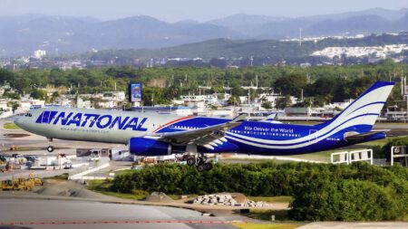A National Airlines Airbus A330 aircraft on approach to land, showing the carrier’s blue and grey livery