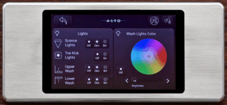Alto Aviation Cadence CMS touchscreen control panel with brushed metal surround, displaying a lighting control screen with wash lights colour wheel on a dark interface.