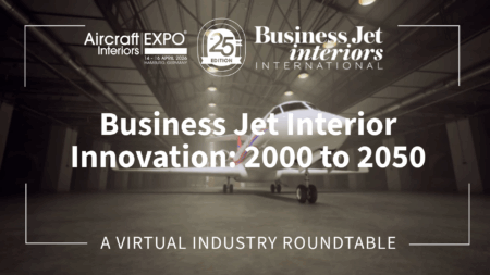 Thumbnail graphic for a virtual industry roundtable titled 'Business Jet Interior Innovation: 2000 to 2050', hosted by Business Jet Interiors International in partnership with Aircraft Interiors Expo 25th Edition, held 14-16 April 2026 in Hamburg, Germany. The background shows a business jet parked inside a large aircraft hangar, with moody, low-contrast lighting. Text and logos appear in white against the darkened image.