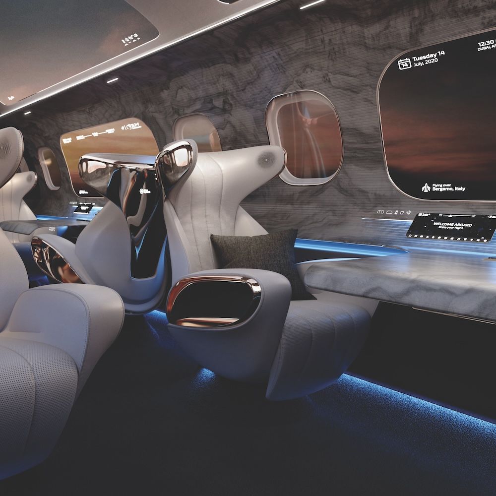 A concept render of a private jet interior featuring sculpted cream leather seats with chrome headrest surrounds, blue ambient lighting and digital sidewall displays showing flight information.
