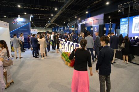 Visitors networking on the exhibition floor at BAAFEx 2025 in Singapore, with exhibitor stands and event signage visible in the background
