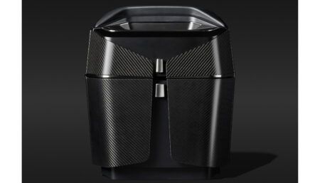 Dark, angular cabinet unit with a carbon fibre weave surface finish and satin black varnish corpus, designed for the Airbus ACH140 helicopter cabin interior.