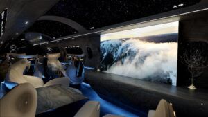 A dramatic widebody cabin concept interior (Maverick) with a starfield ceiling, large LED wall display and curved seating.