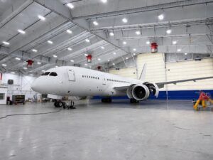 White Boeing 787 Dreamliner inside a VIP completion hangar