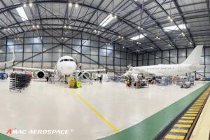 Interior of aircraft MRO hangar with two white jets