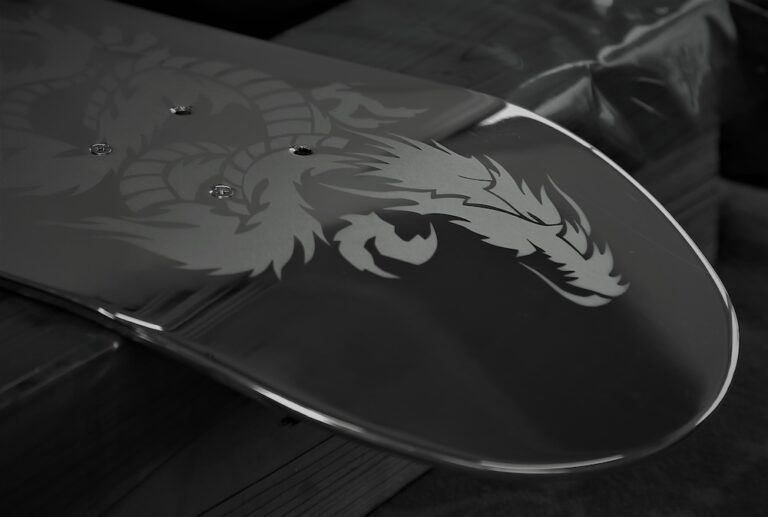 Close-up photograph of a stainless steel panel featuring an intricately etched dragon motif.